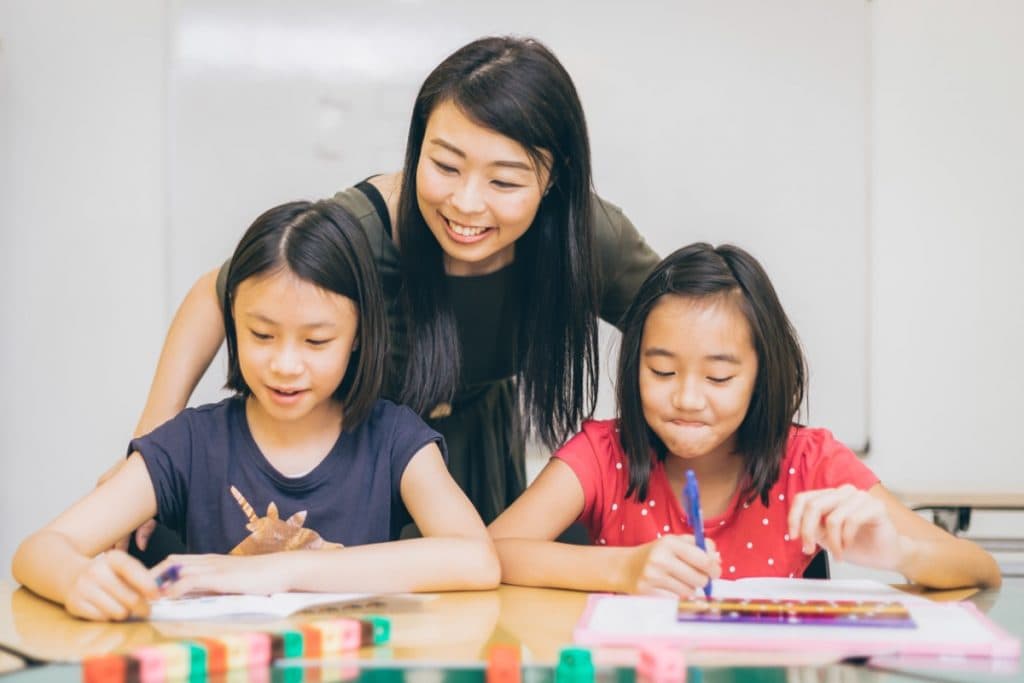 Students learning Singapore Math with teacher